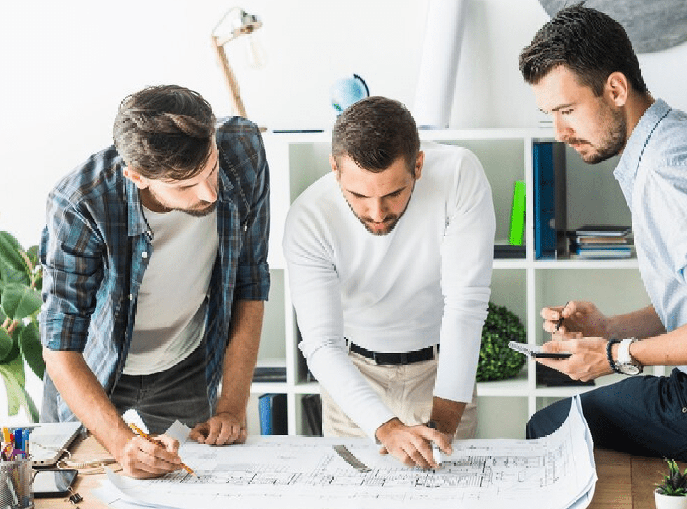 Group of male architect analyzing blueprint