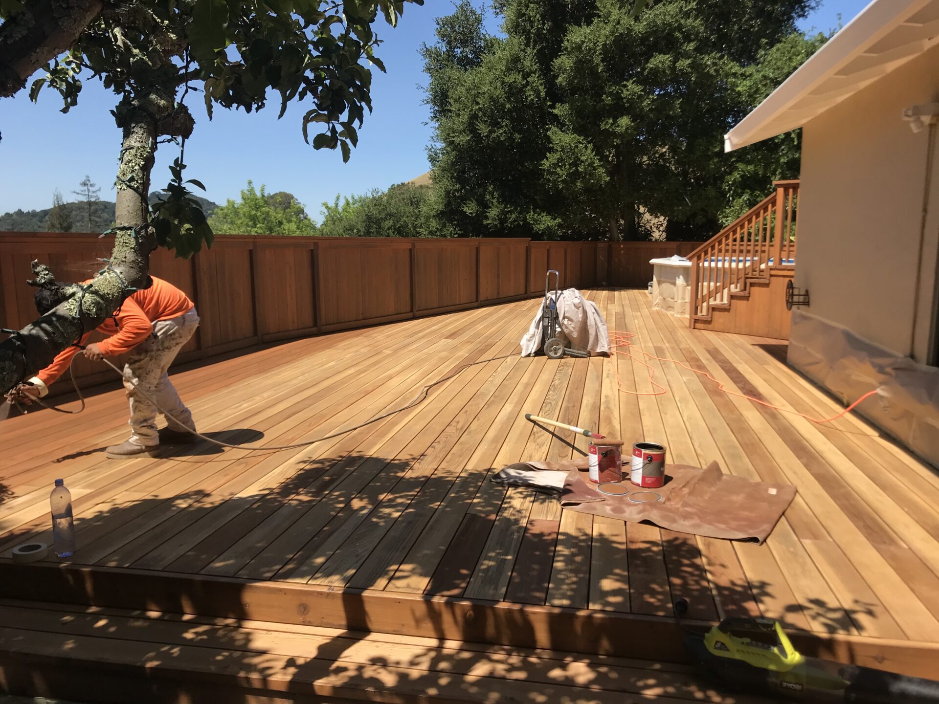 a backyard deck being constructed by two men